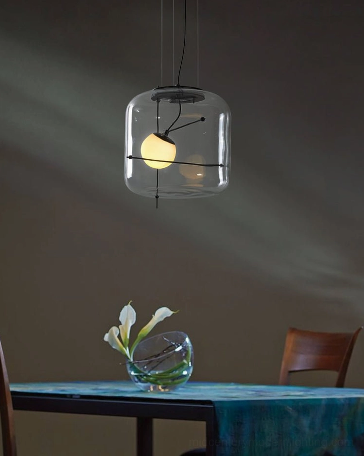 Amber glass Plot pendant lamp above cozy dining area with blue tabletop and dark accent wall