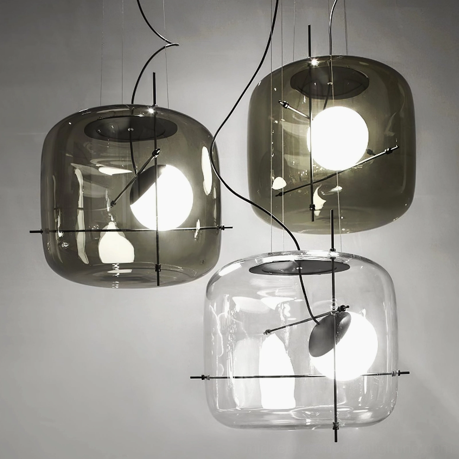Plot pendant lamp with black metal framework and clear or amber glass shade options