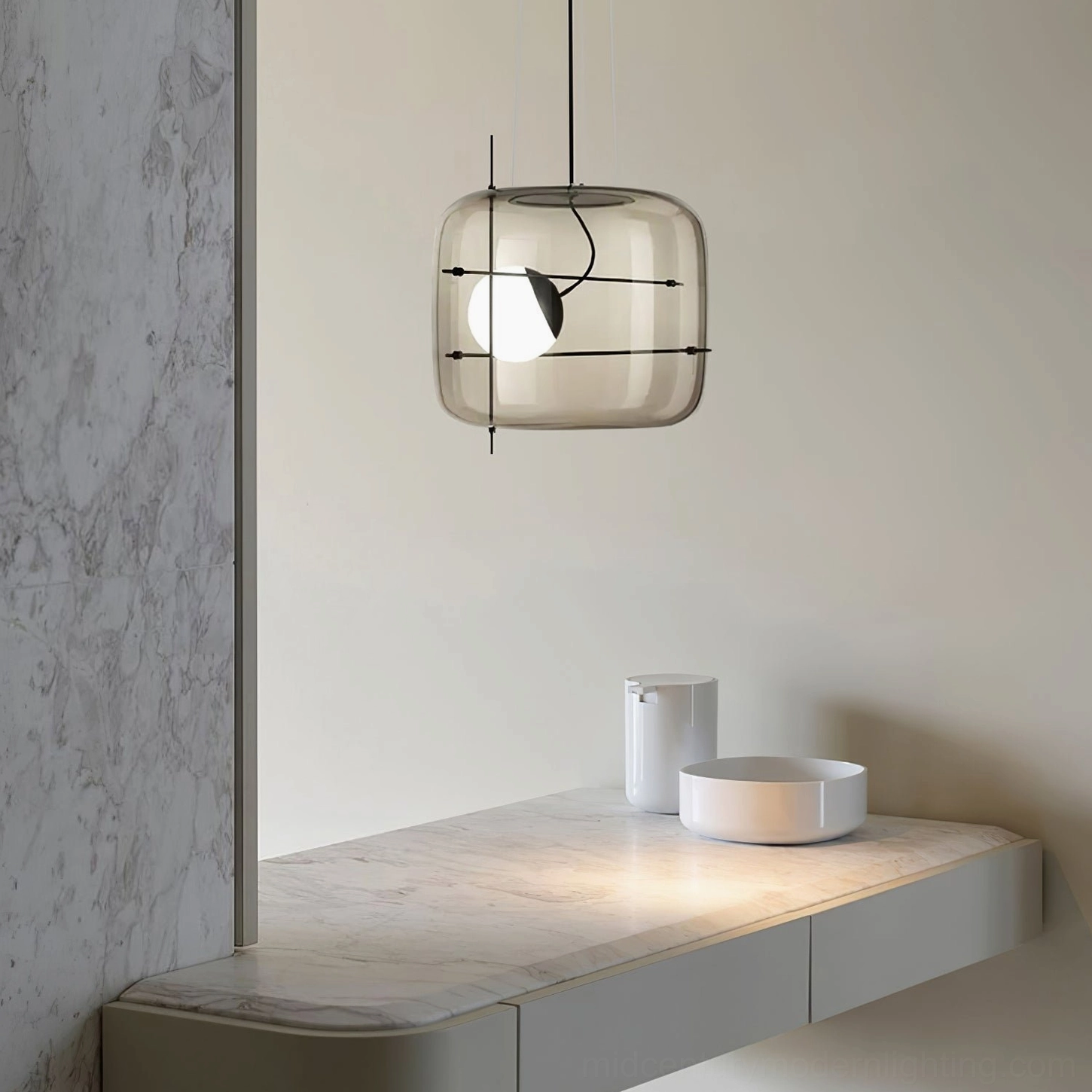 Smoked grey glass pendant light with black suspension cord, side eye-level view in minimalist vanity space
