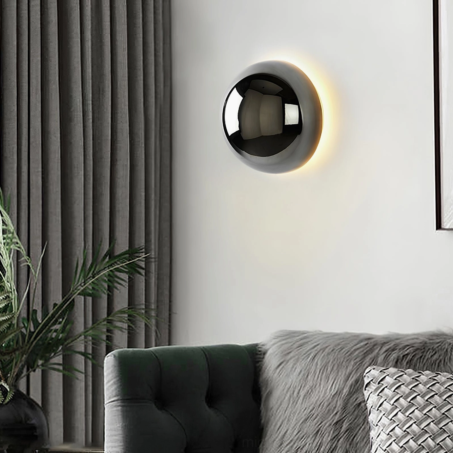 Polished chrome adjustable wall sconce creating sculptural light effect on interior wall