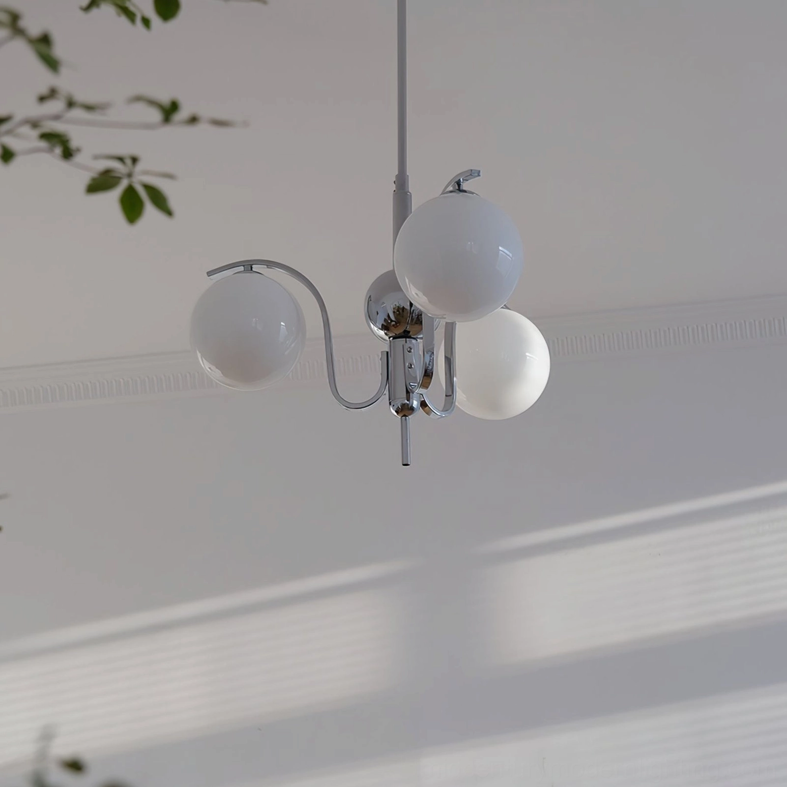 Polished chrome glass globe chandelier with spherical shades reflecting ambient light
