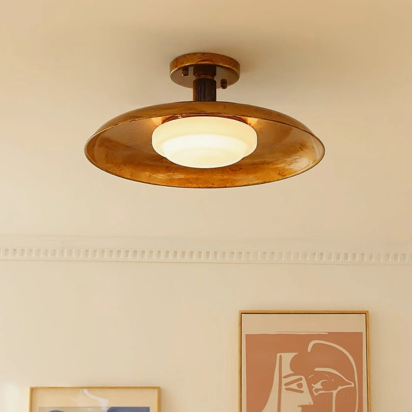 Fully illuminated vintage pot-lid flush mount ceiling light emitting warm glow in mid-century modern room