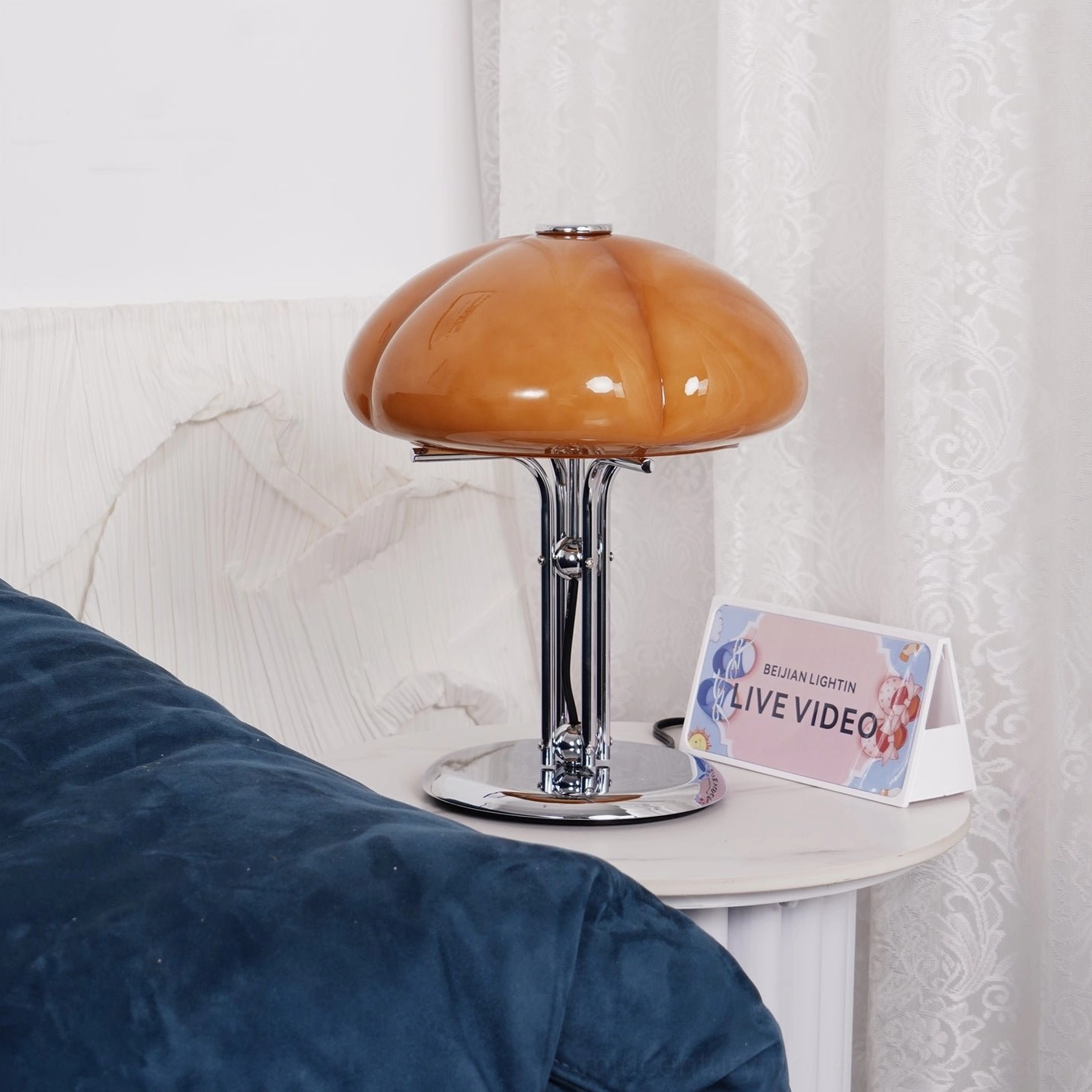 Quadrifoglio four-leaf clover table lamp product detail shot, showing hand-shaped amber glass and chrome hardware close-up