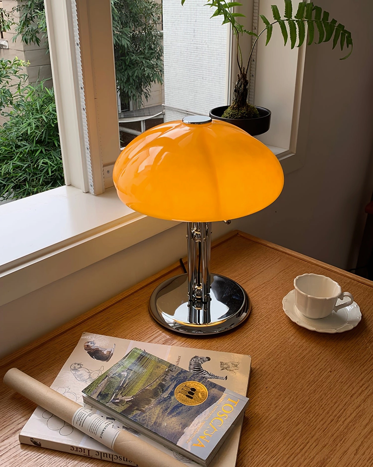 Quadrifoglio table lamp on entryway console surface, architectural interior styling with warm ambient lighting