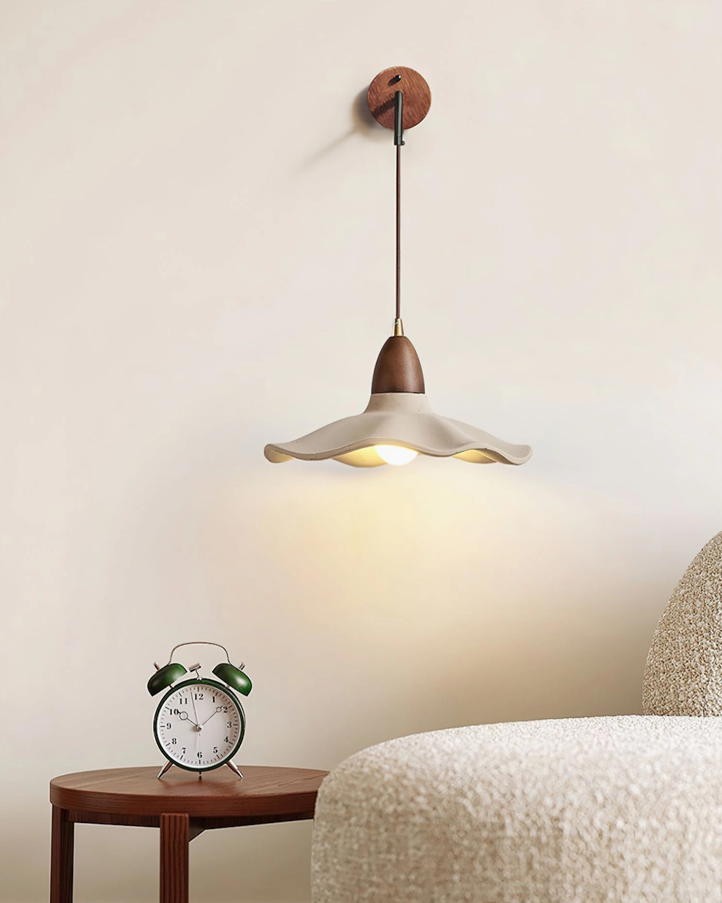 Radha concrete wall lamp installed in bedroom beside alarm clock, cozy intimate lighting atmosphere