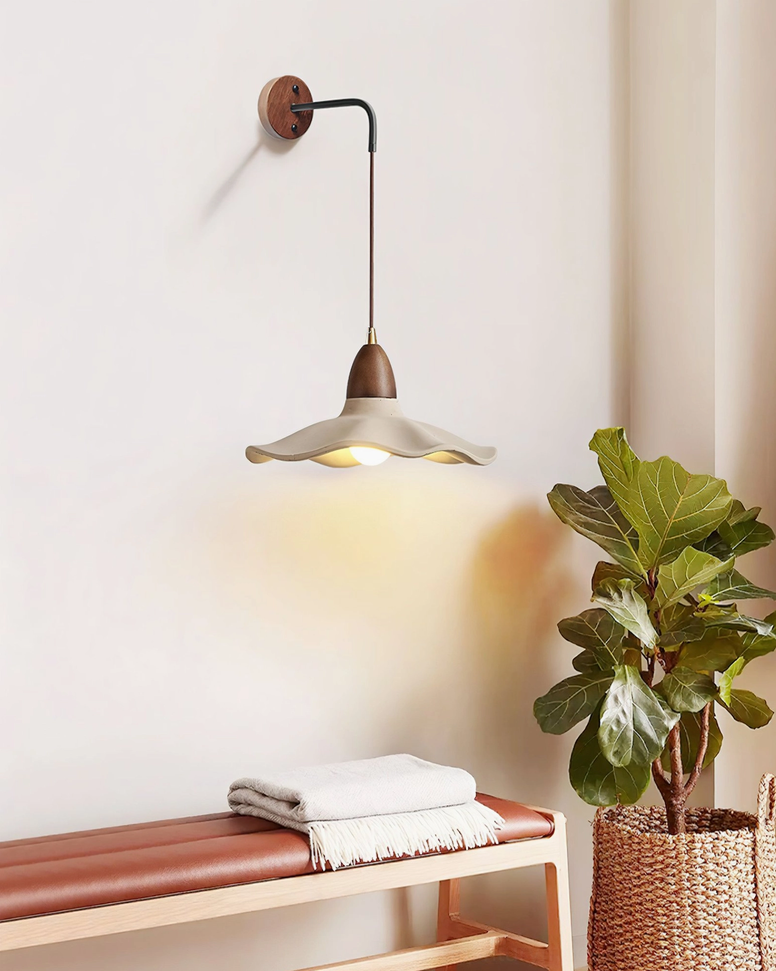 Radha wall lamp side installation in entryway above bench with towels and plant, warm minimalist entry lighting