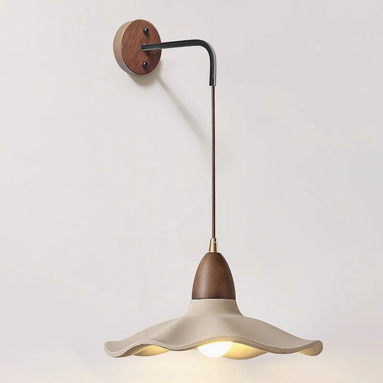 Radha modern wall lamp with grey concrete and walnut finish, front-facing display of organic wave pattern