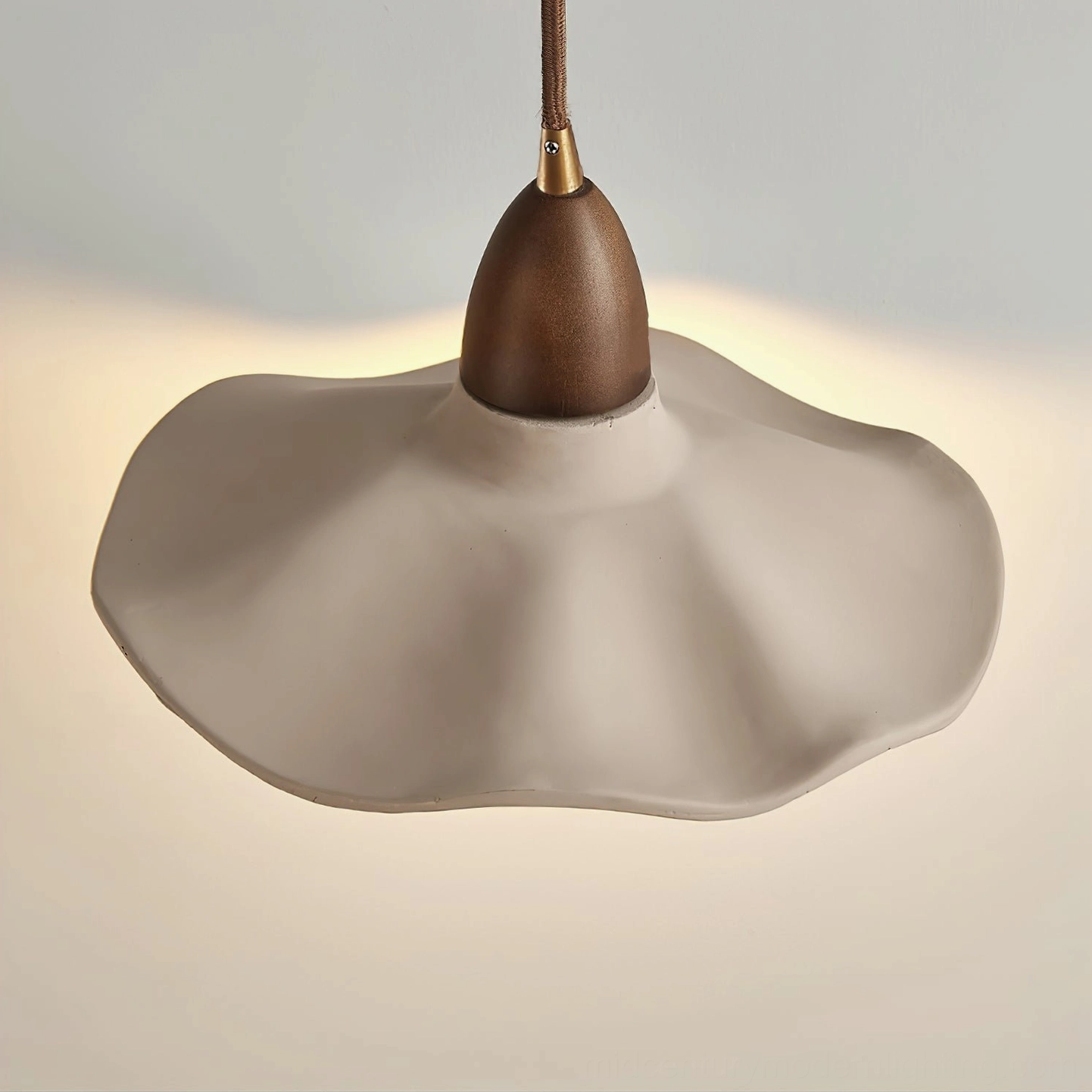Radha mid-century modern wall lamp with grey concrete finish and warm wood arm, architectural detail view