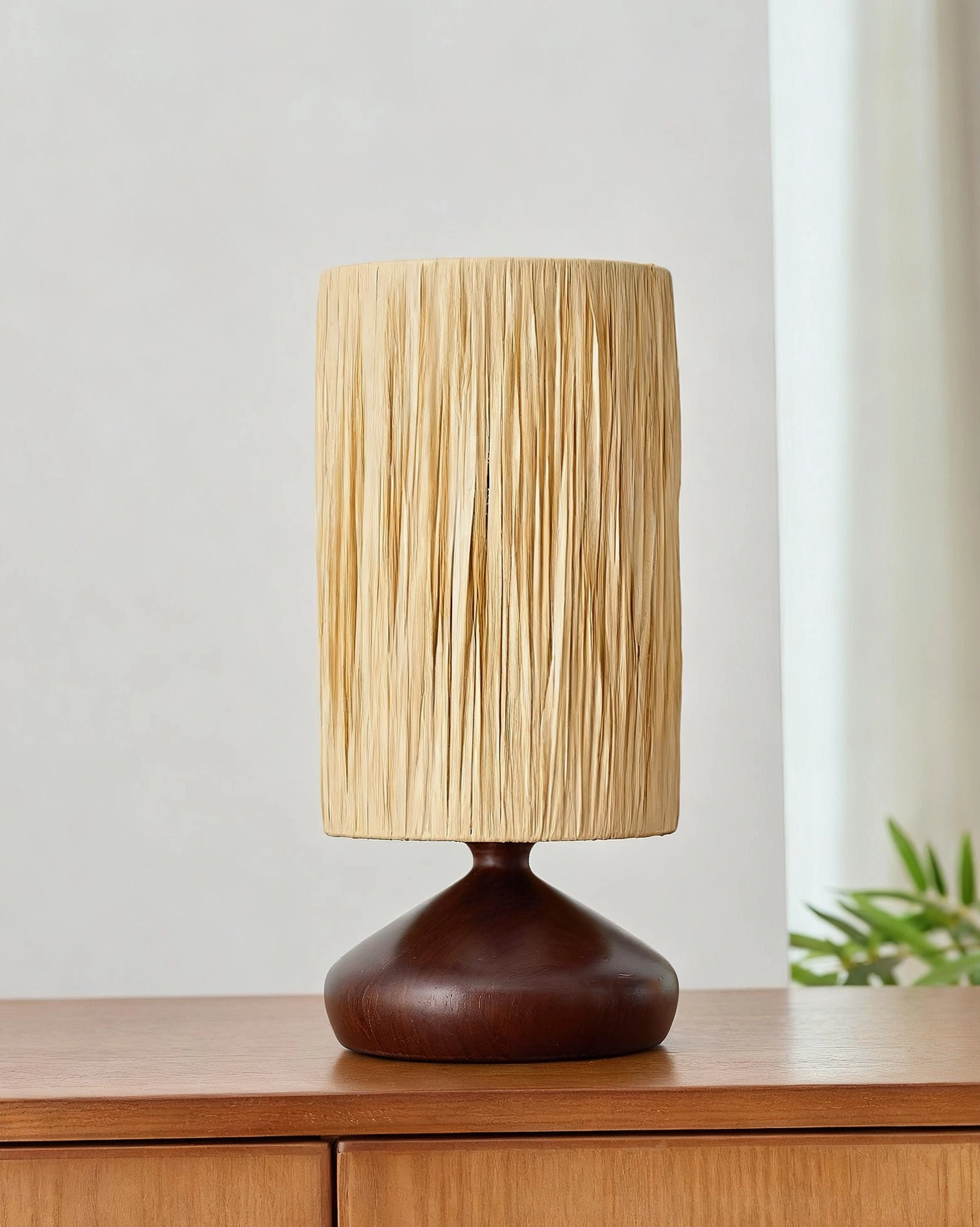 Solid dark walnut wood base with tight hand-woven raffia shade on wooden dresser, neutral natural aesthetic