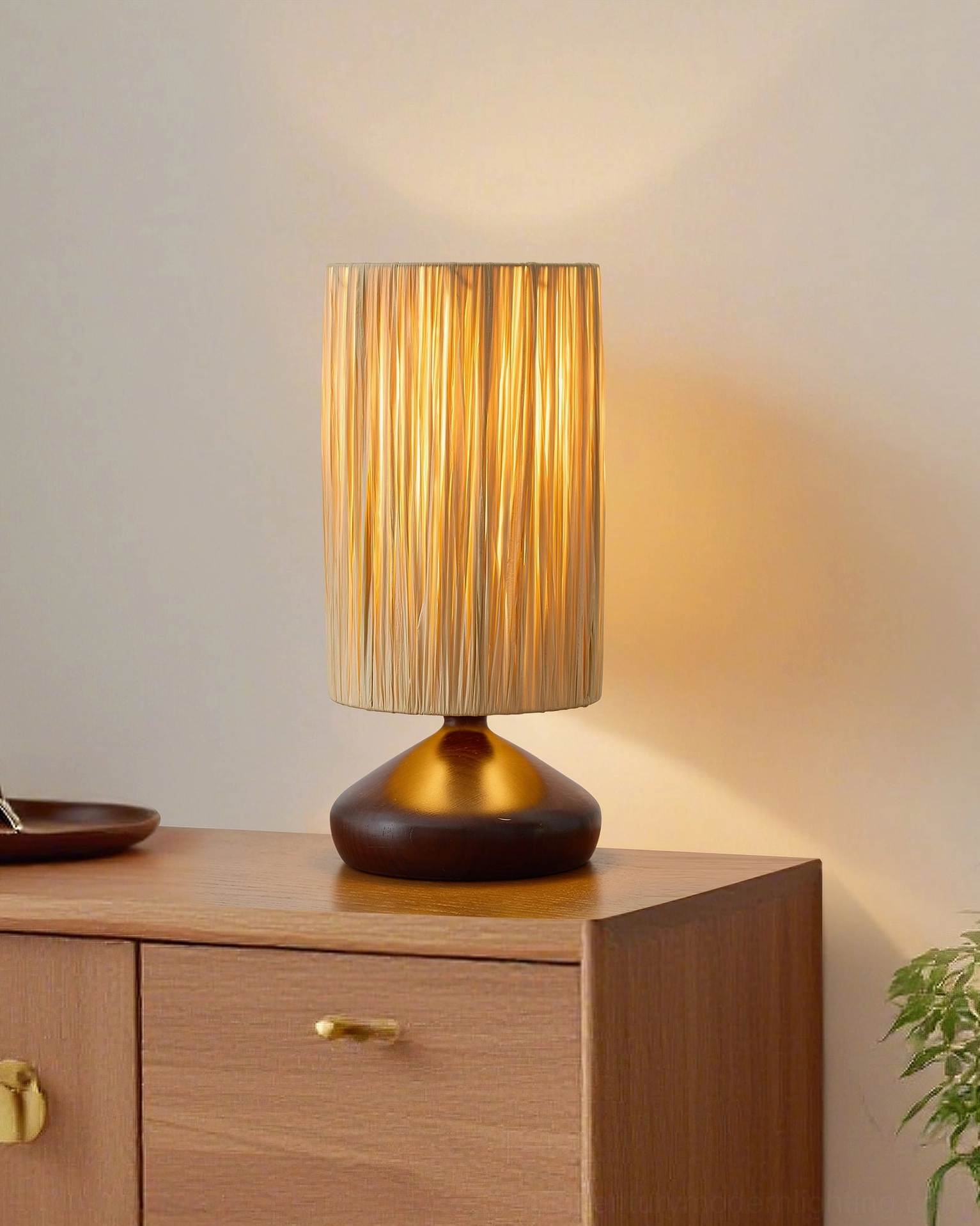 Natural beige raffia shade with dark walnut base on wooden cabinet corner, minimalist boho home interior styling