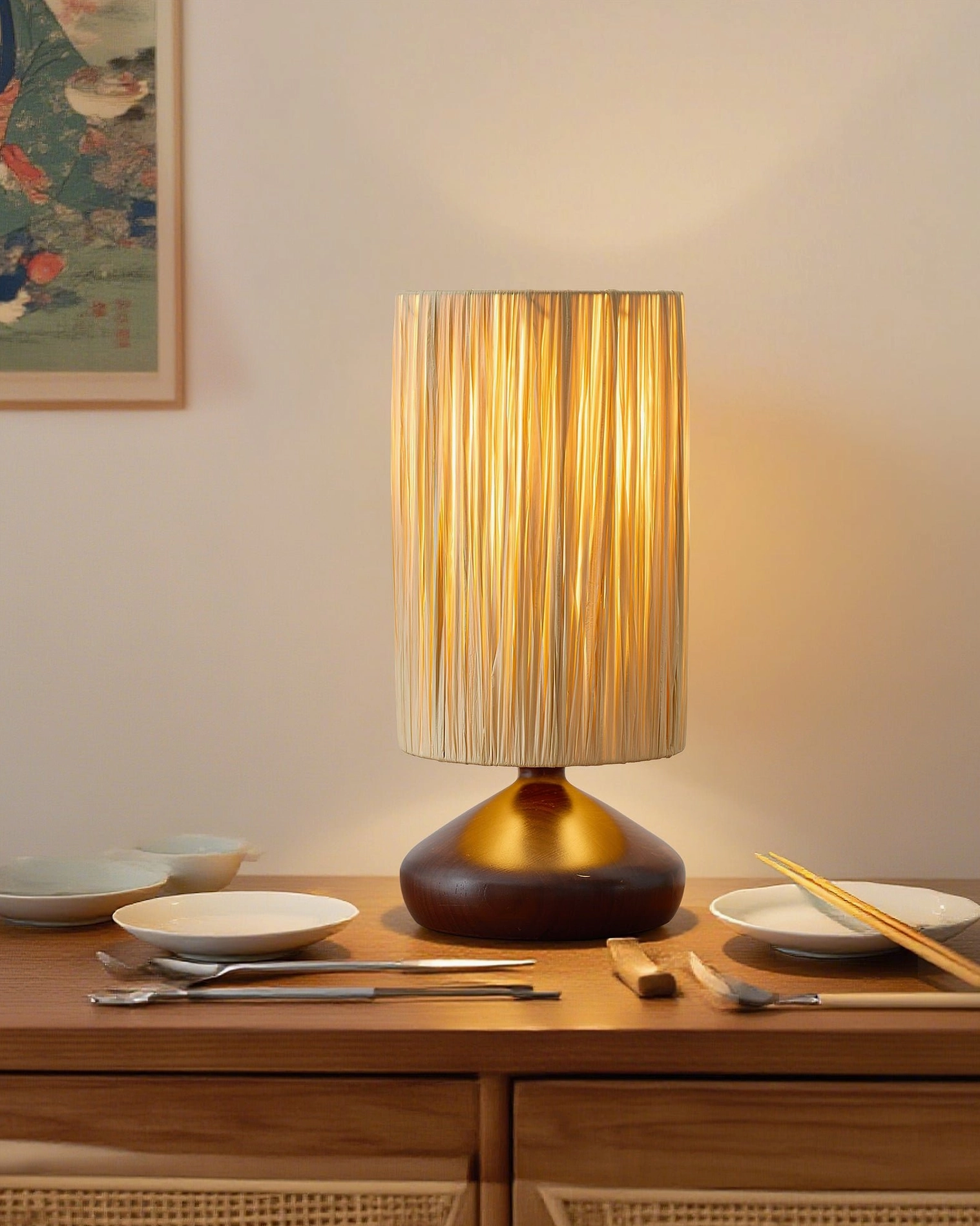 Table lamp with illuminated raffia shade on dining side table with tableware, japanese minimalist home decor