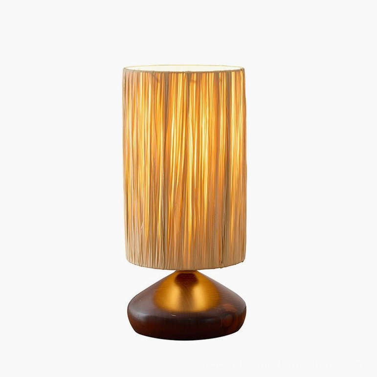 Illuminated raffia table lamp studio front view, polished dark walnut base, warm organic glow on white background