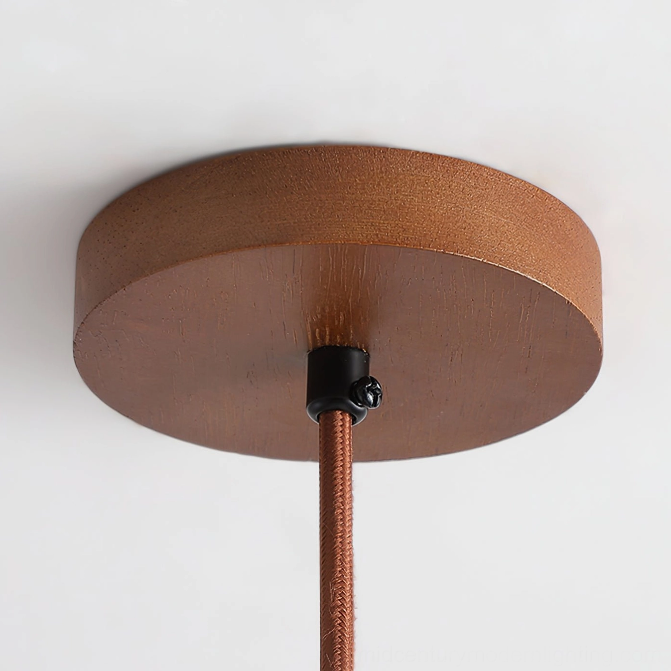 Ceiling mount hardware of Randolf pendant lamp featuring walnut wood-grain finish and black metal connector