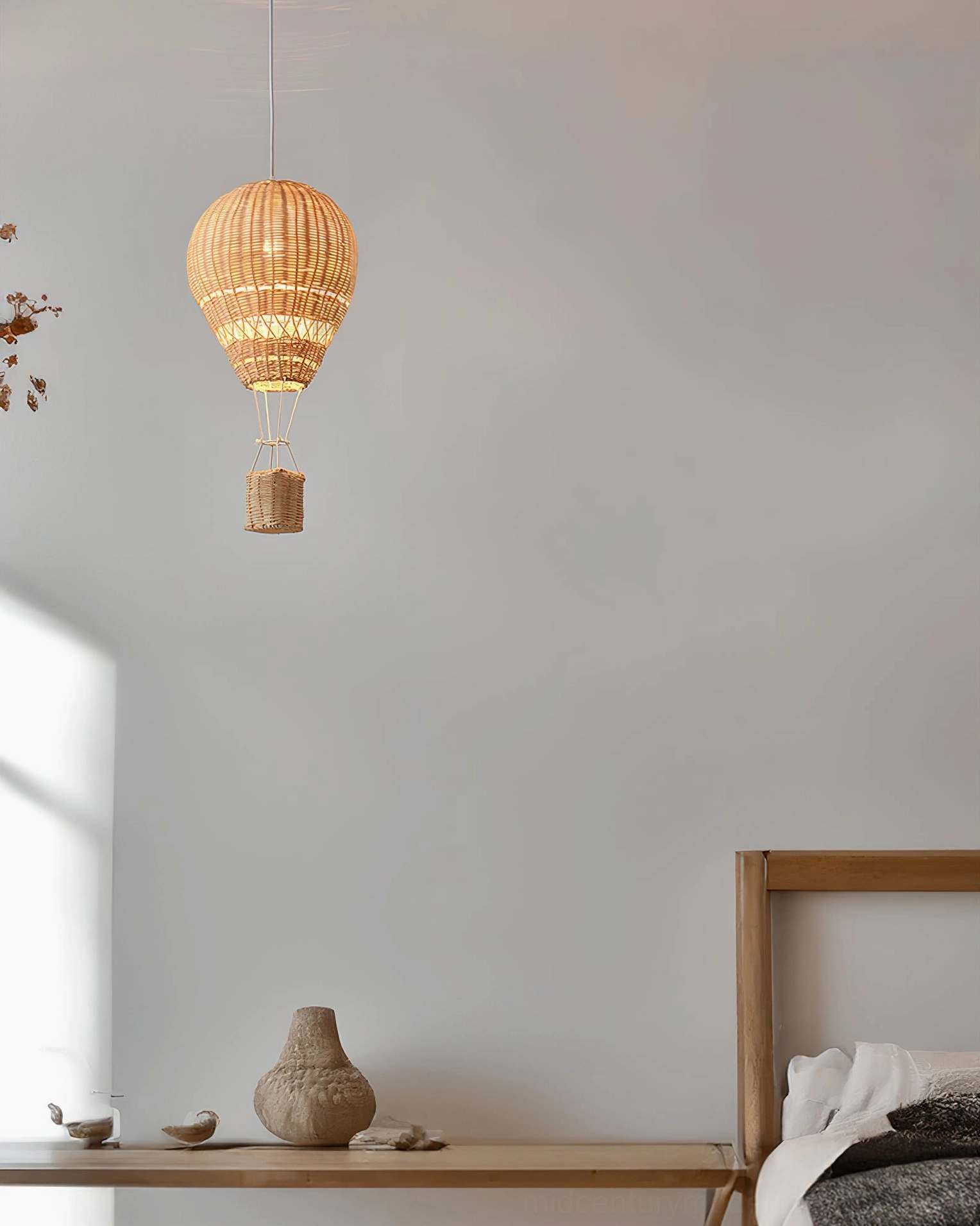 Rattan handwoven hot air balloon pendant light in minimalist Scandinavian bedroom