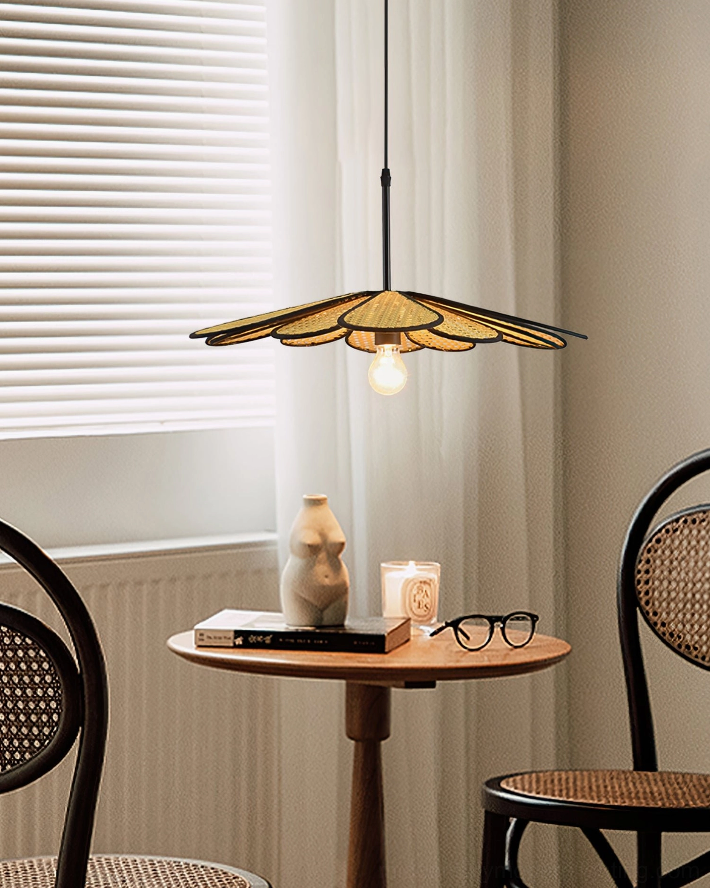 Handwoven botanical pendant light in coffee nook interior with window, natural woven texture and black frame detail