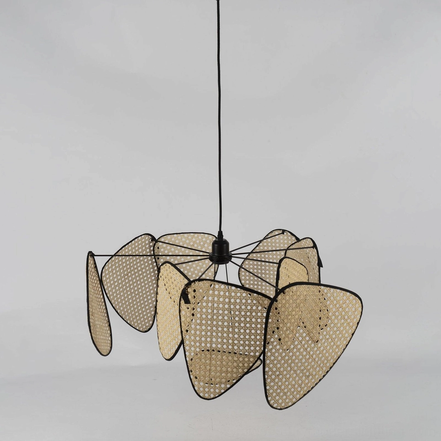 Rattan cluster pendant light artistic product photography, woven bamboo shades with warm studio lighting