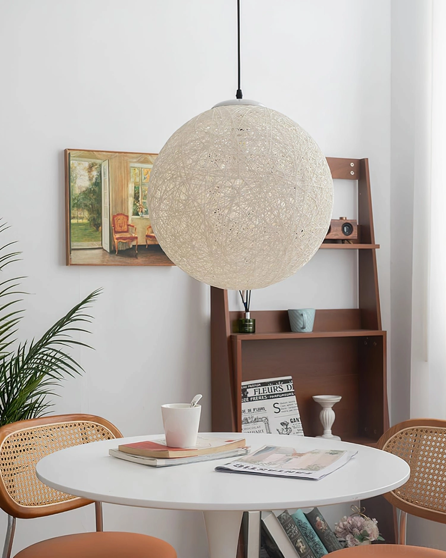 Natural rattan globe pendant light cozy modern dining corner warm minimalist aesthetic