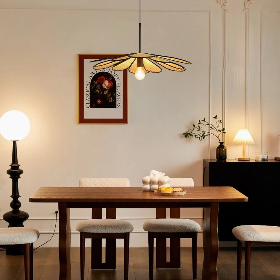 Sculptural rattan flower pendant in formal dining room with upholstered chairs, table lamp, and wall artwork accent