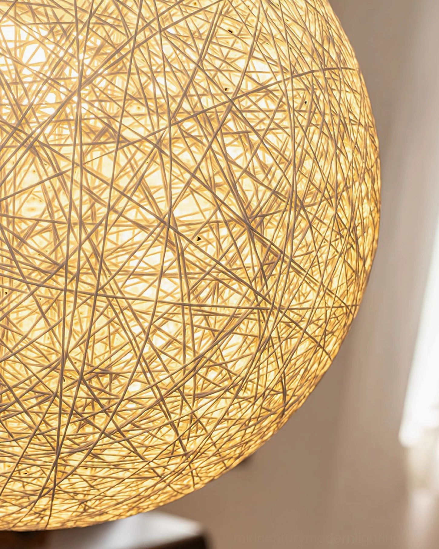 Close-up lit wicker pendant lamp soft warm glow woven texture detail