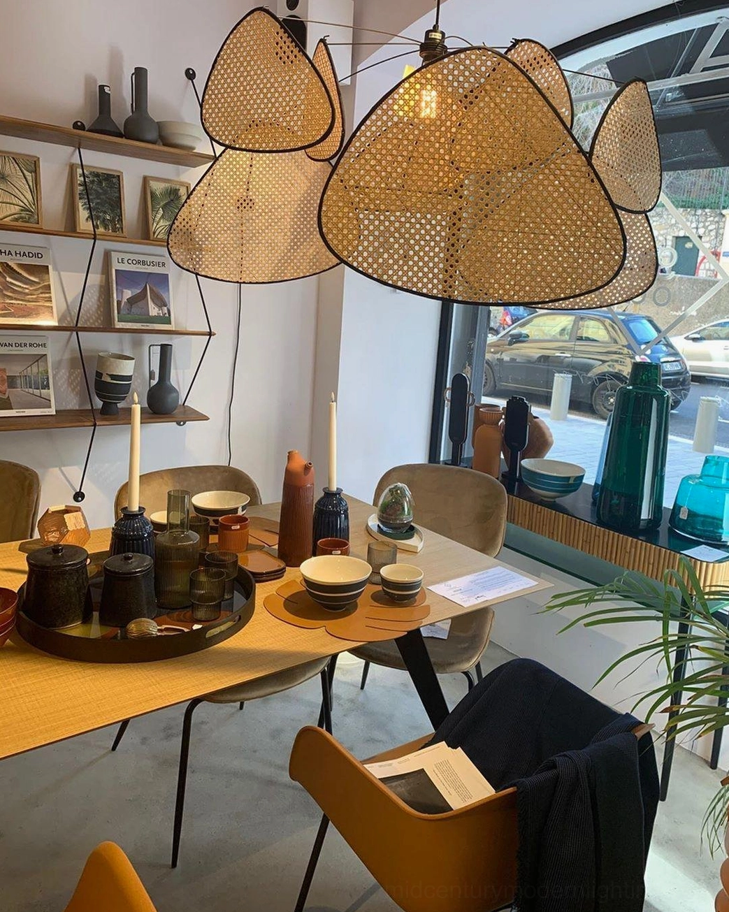 Rattan pendant light in minimalist bedroom reading nook, soft warm ambient lighting