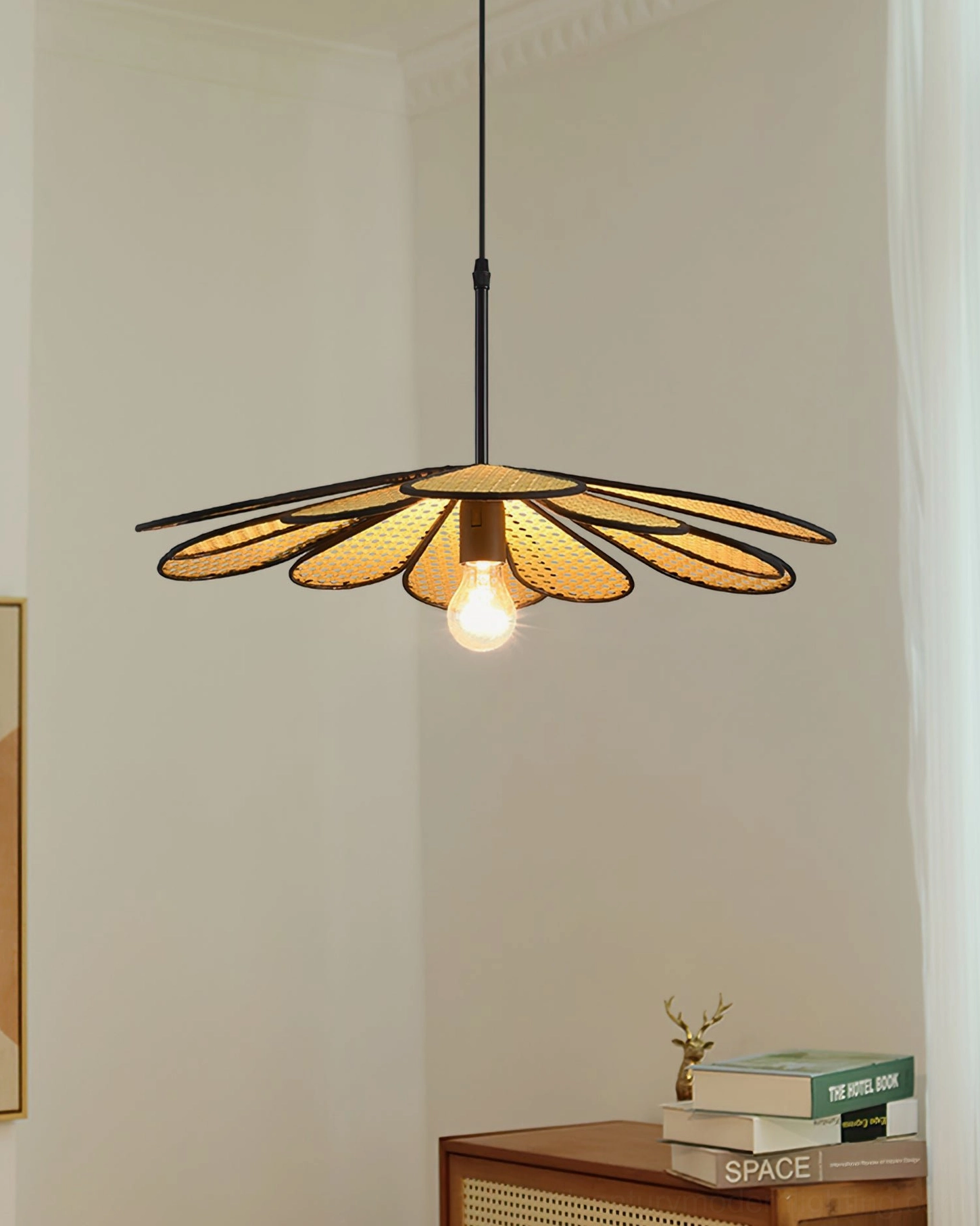 Rattan flower pendant fixture showing warm light diffusion through woven shade creating atmospheric shadow patterns