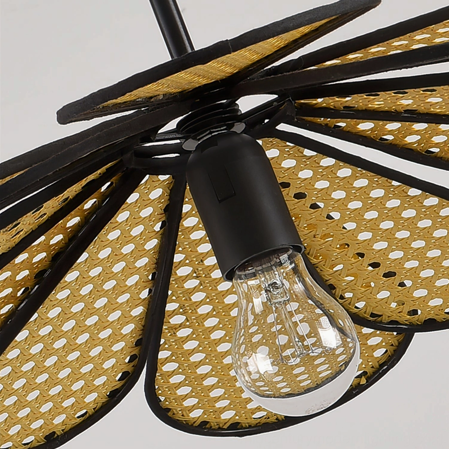 Organic rattan pendant light design detail showing intricate hand-woven petal structure and metal frame construction