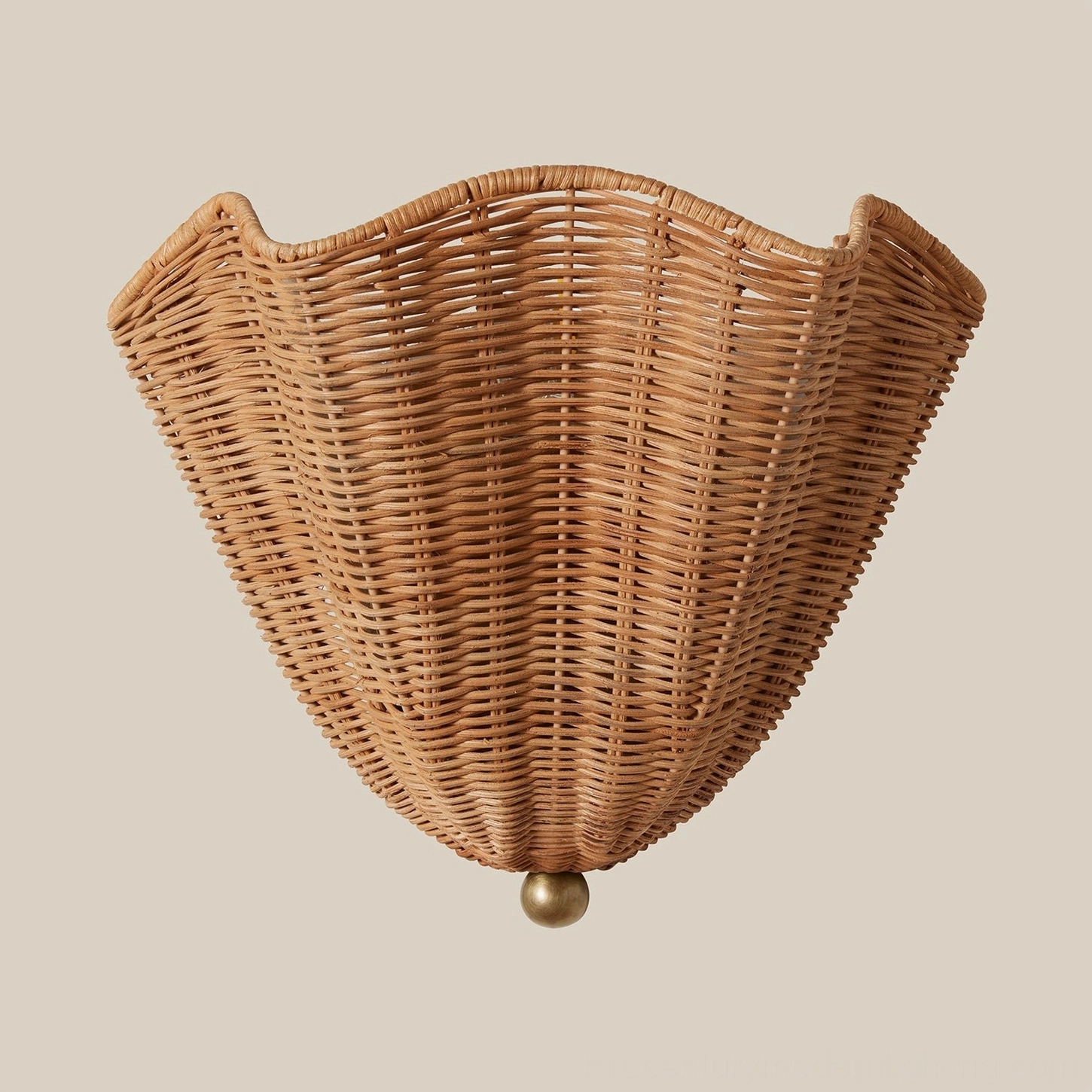 Sarasota rattan wall sconce mounted on bedroom wall, warm light through woven shade creating shadow pattern