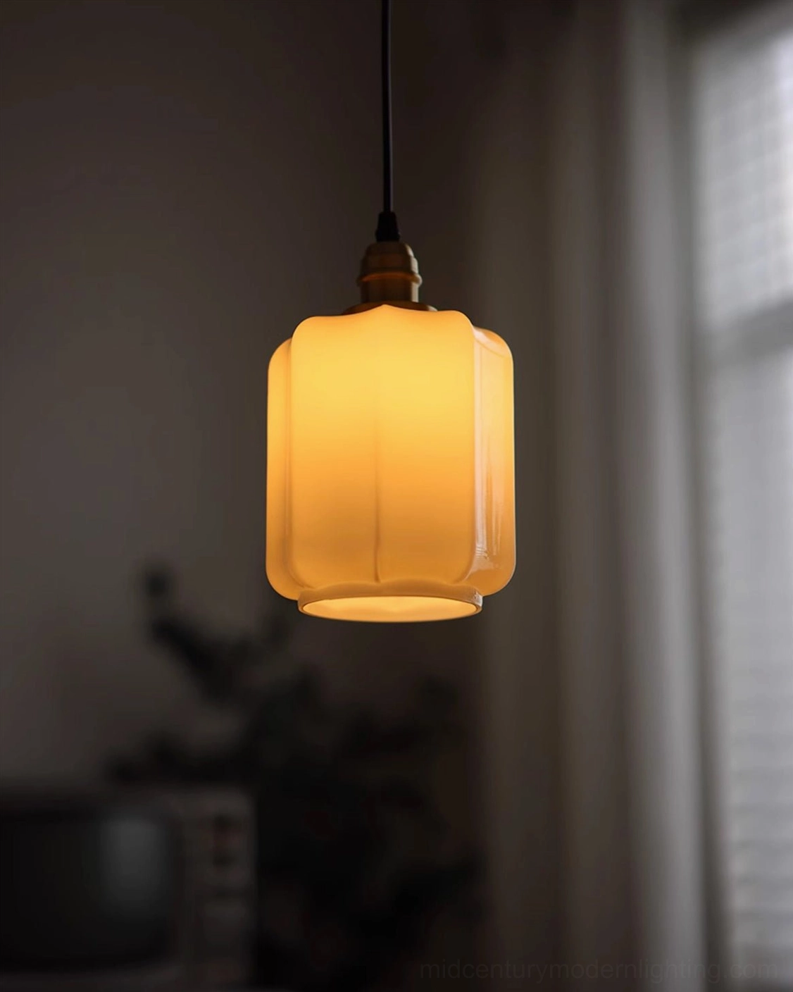 Rayburn cylindrical ribbed pendant light illuminated with brass top and warm amber glass shade