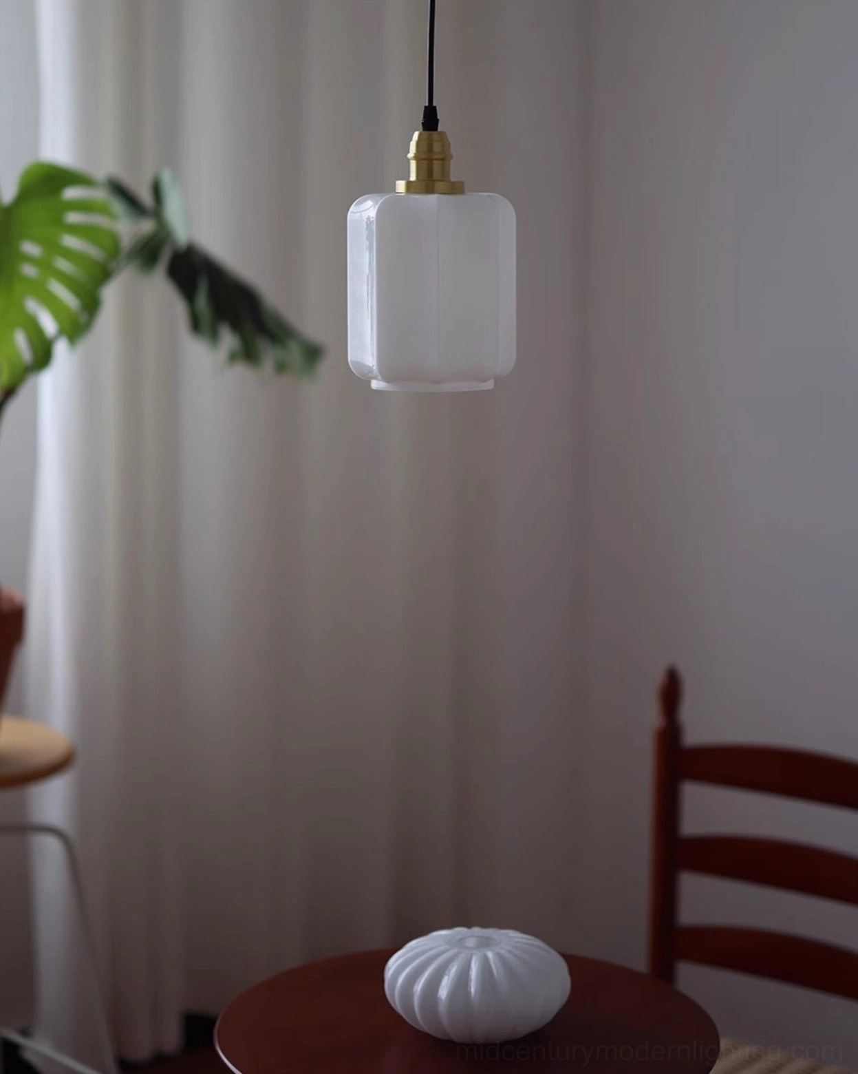 Rayburn square ribbed milk glass pendant light hanging in modern minimalist home with wooden furniture