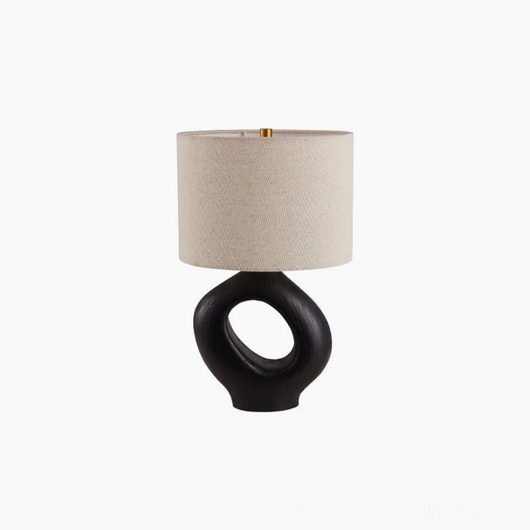 Sauce table lamp beside stacked books and natural fiber accessories, curated reading nook styling