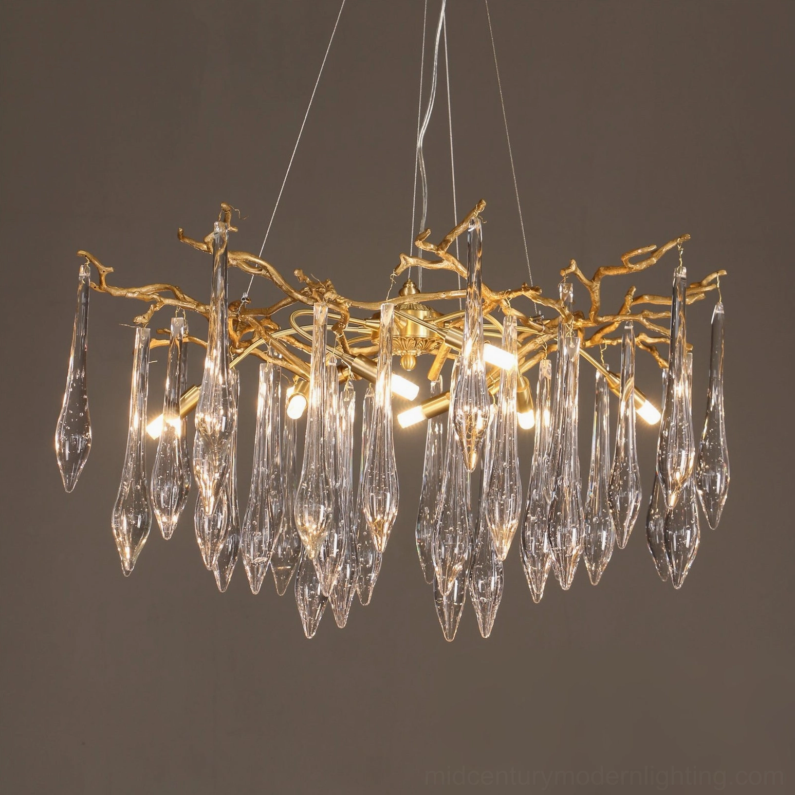 Rectangular branch crystal chandelier left three-quarter view warm glowing bulbs illuminated lighting