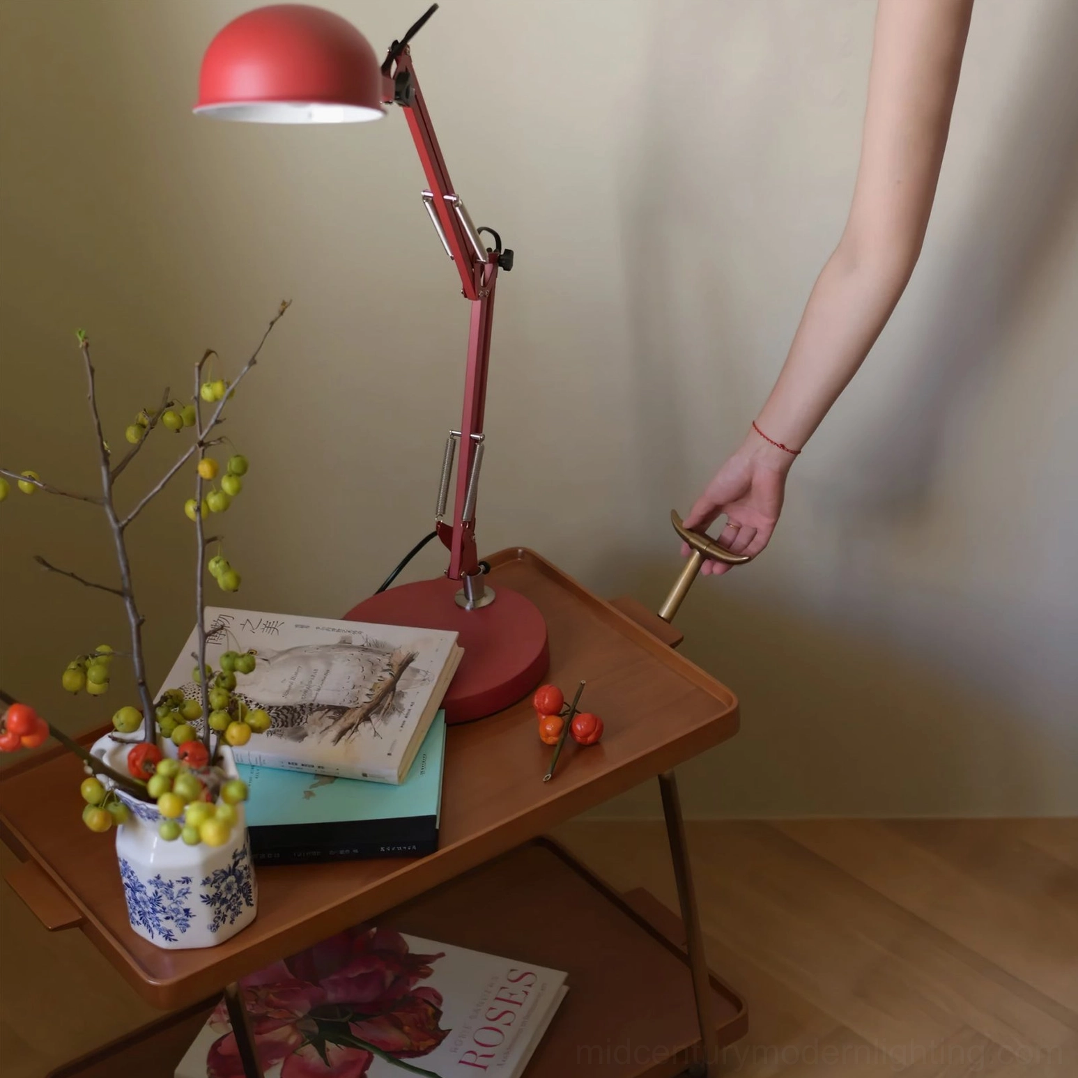 Red adjustable table lamp showcasing matte metal construction and adjustable positioning capability