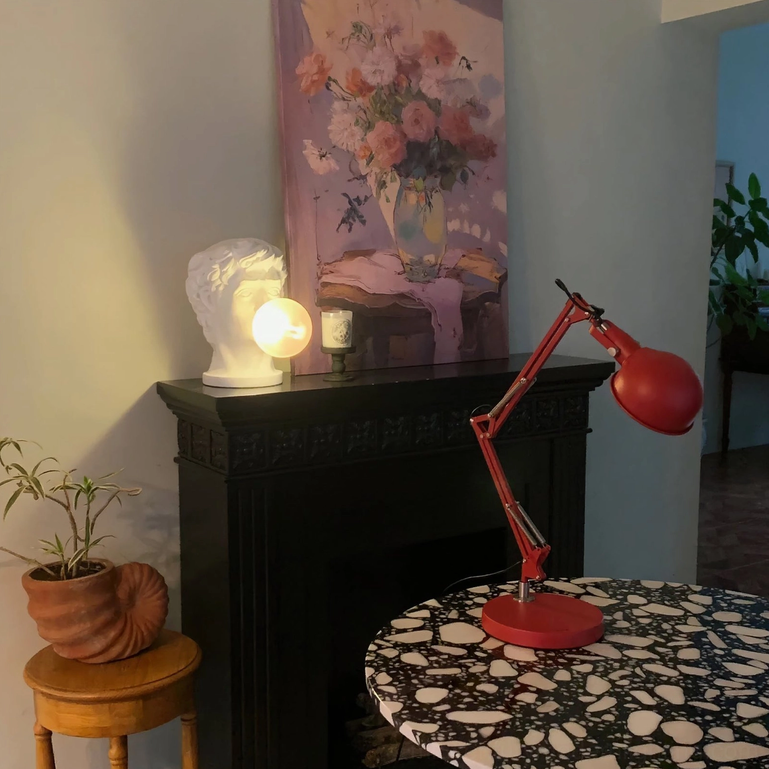 Red mid-century modern table lamp as decorative accent piece in contemporary interior setting