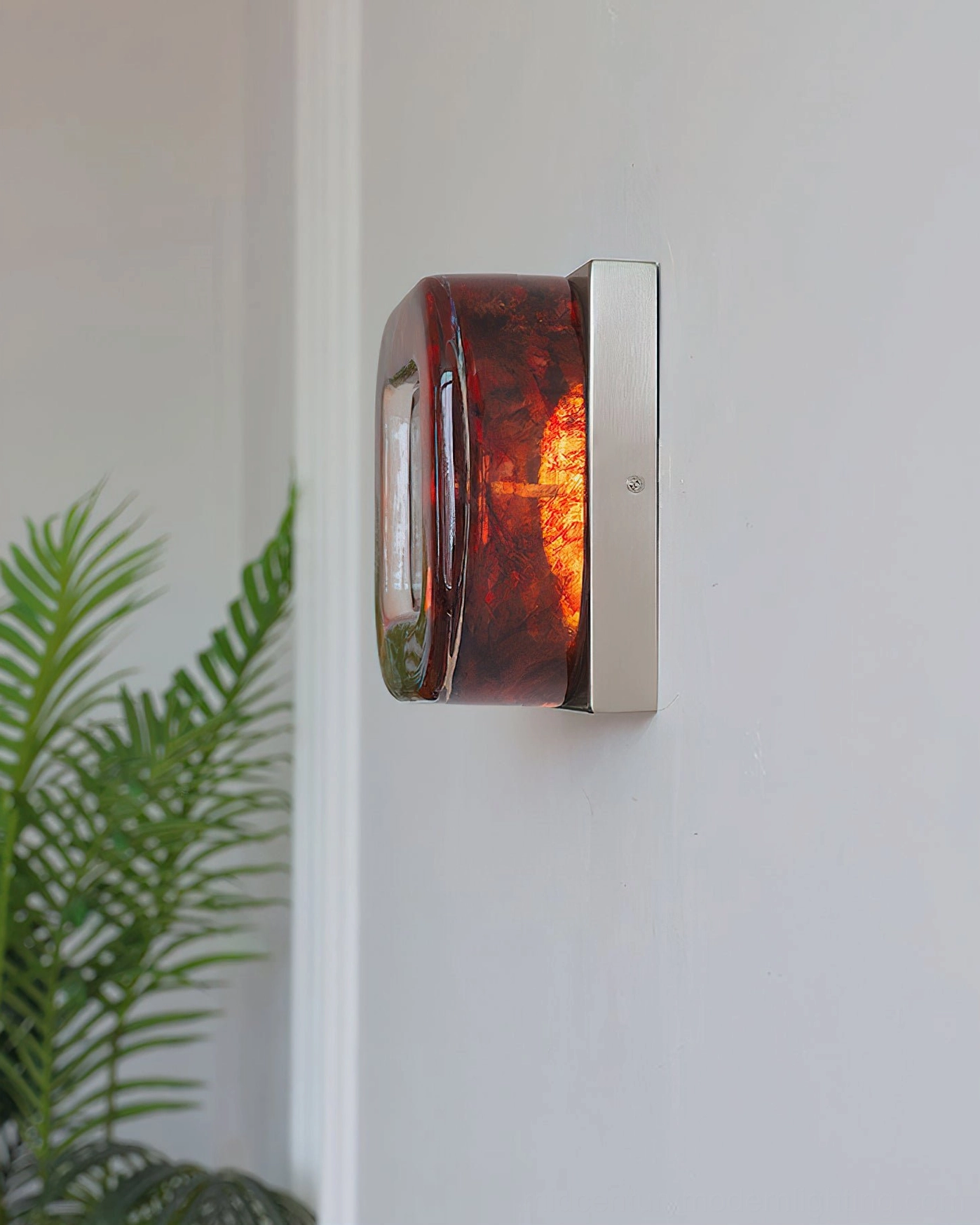 Red circular wall sconce finish and surface texture in natural lighting
