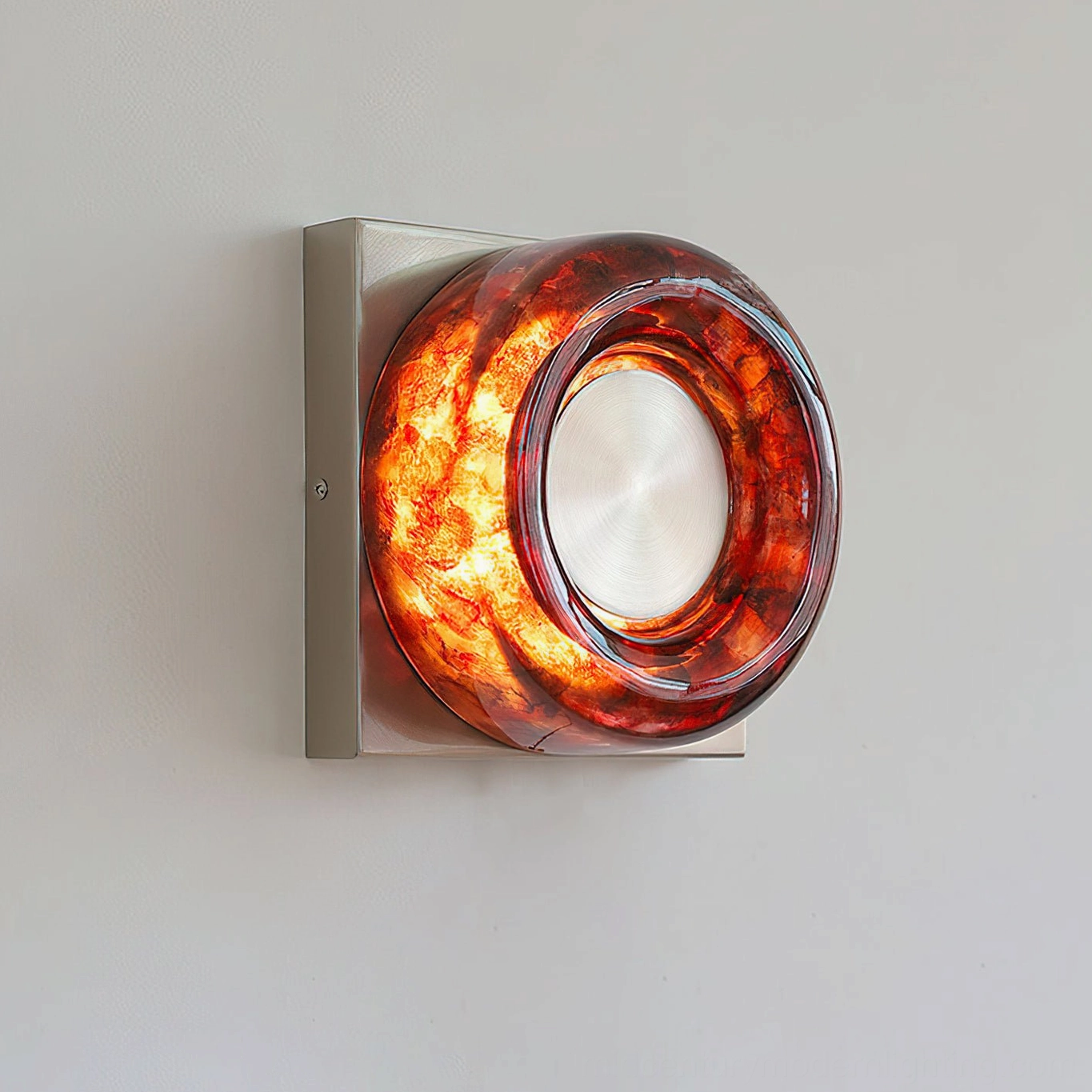 Red wall sconce with gold finish detail mounted on bedroom wall architectural feature