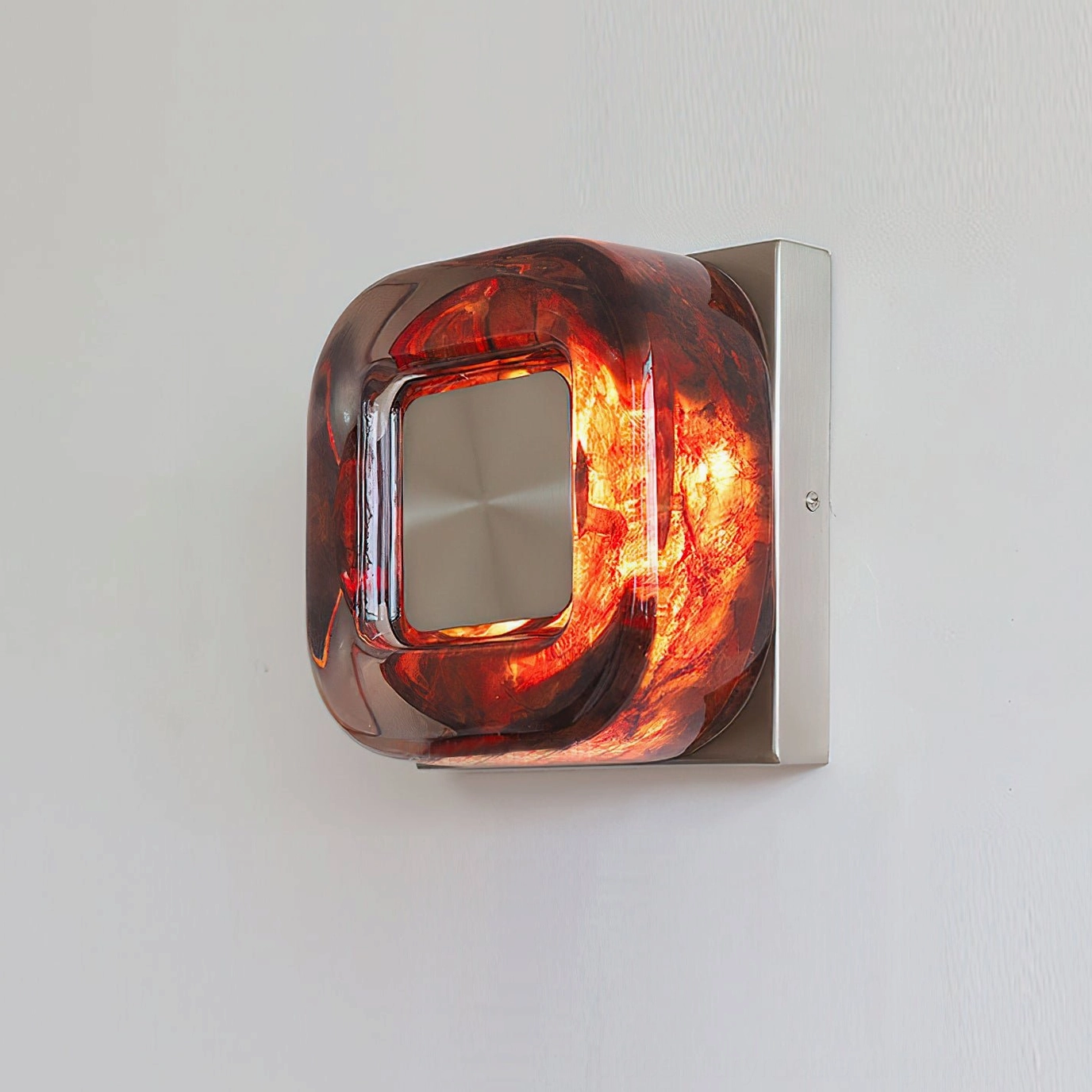 Red circular wall sconce integrated LED warm light performance in residential lighting setup