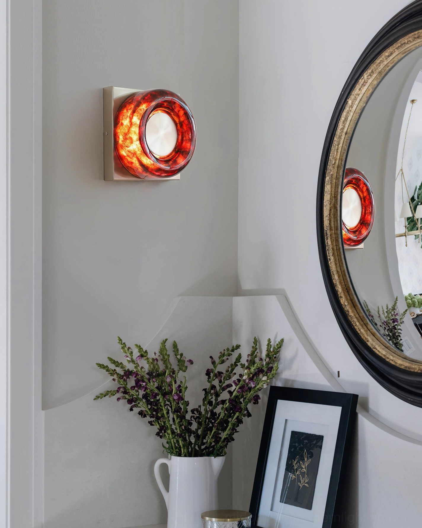 Red resin and metal construction detail of mid-century circular wall sconce