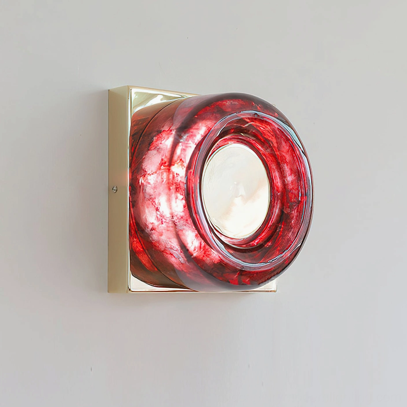 Red circular wall sconce warm light ambiance in cozy residential space