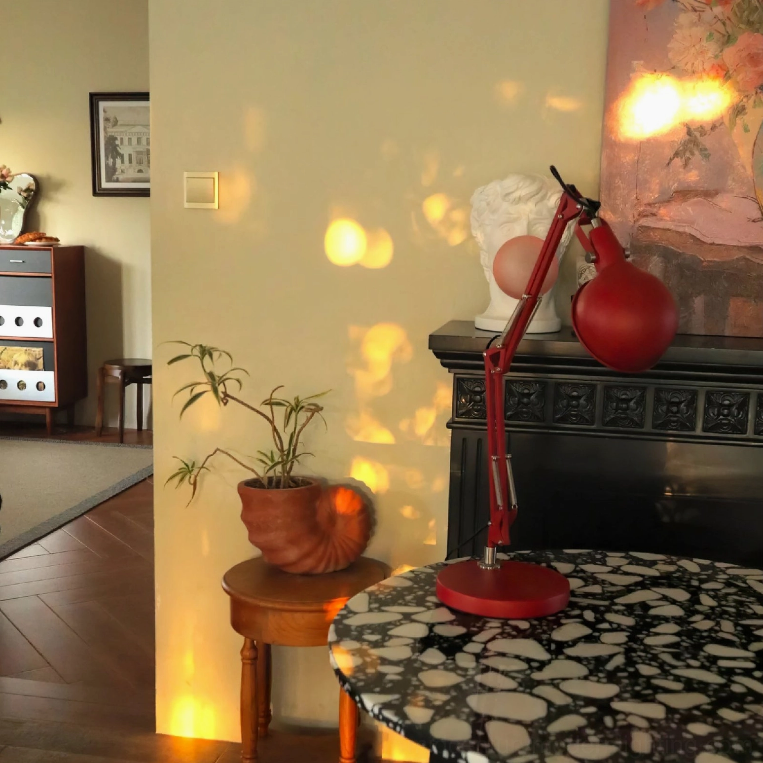 Red swing arm lamp with E14 bulb socket and modern minimalist design aesthetic