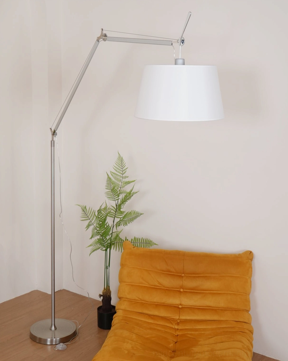 Refined articulating swing arm floor lamp, silver metal framework with elegant white fabric shade detail