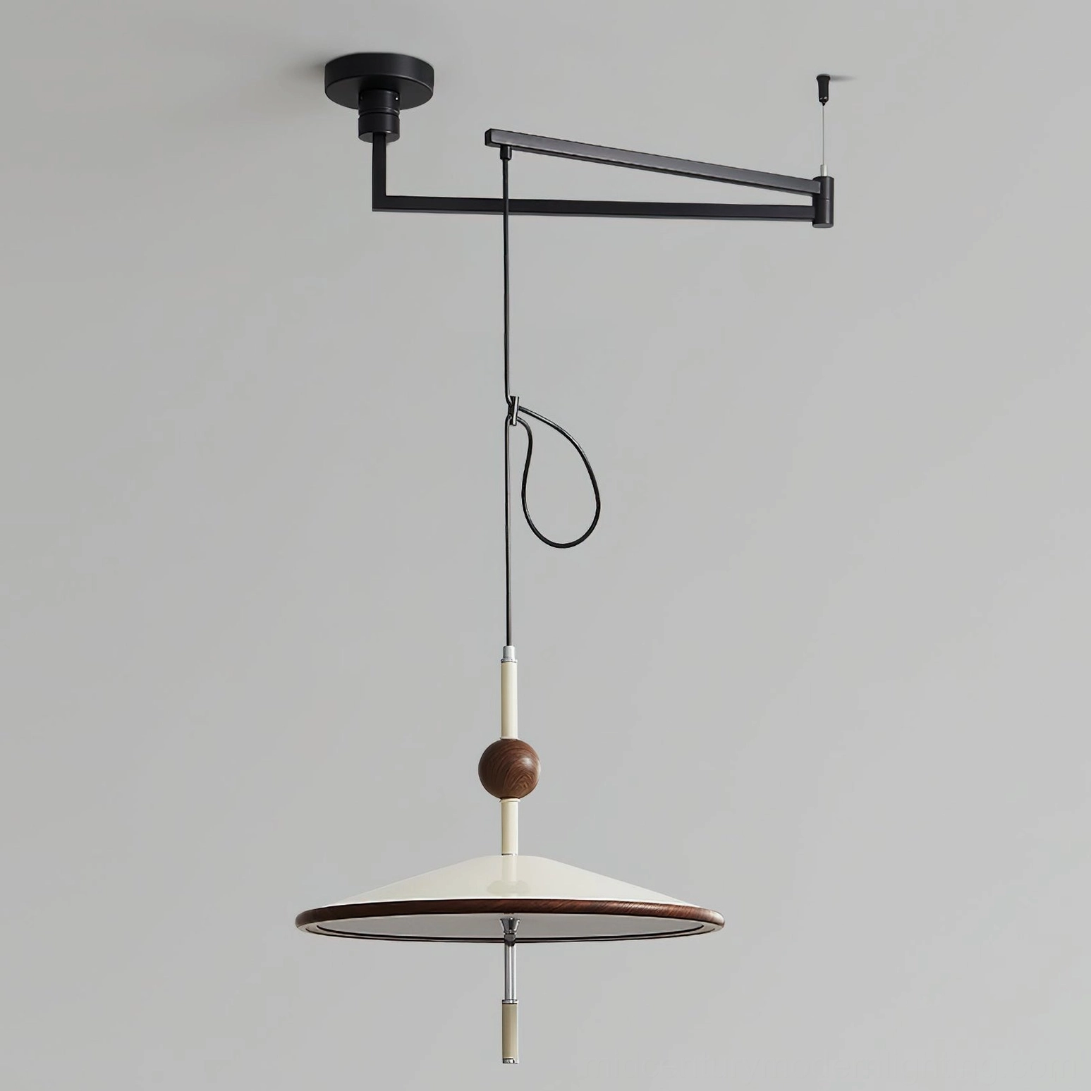 Close-up detail of Remy pendant light featuring black metal swing arm and decorative wooden spherical accent on neutral gray background