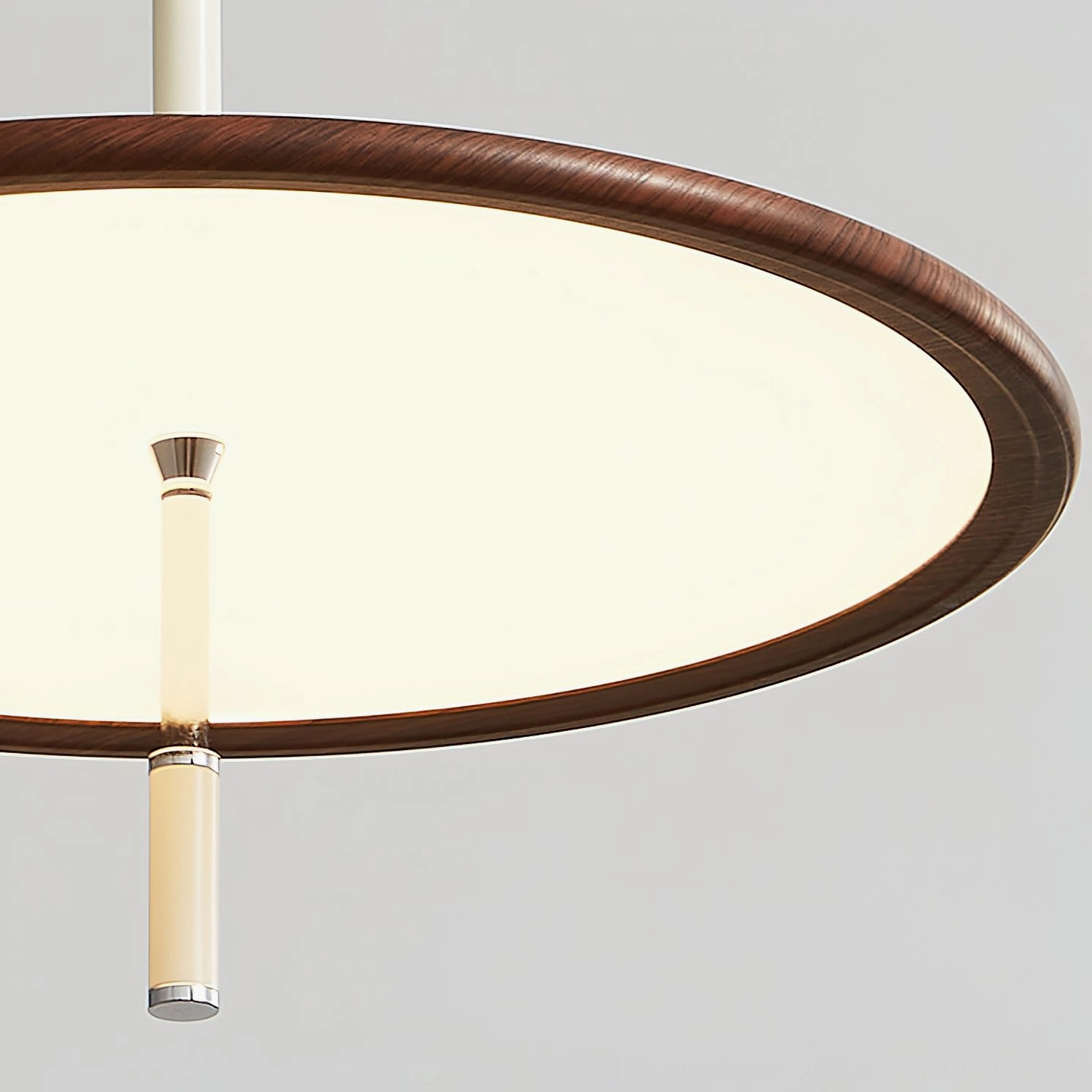 Low-angle close-up of illuminated Remy lamp head featuring glowing disc shade and wooden trim detail against gray studio background