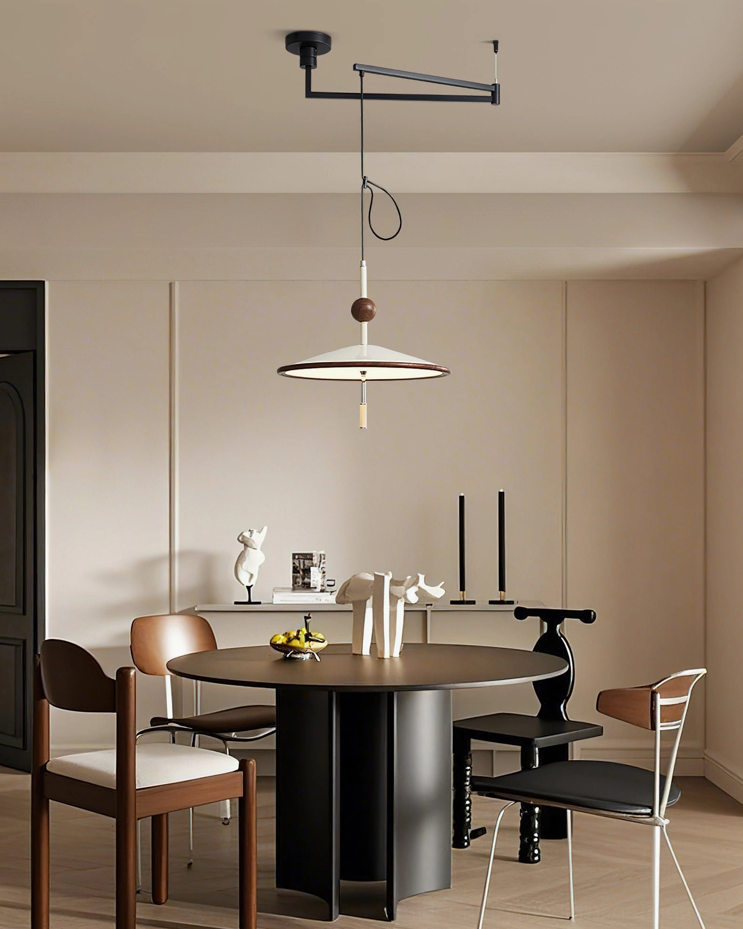 Remy pendant light in contemporary modern dining space with mixed-style chairs and elevated installation showing flexible positioning capability