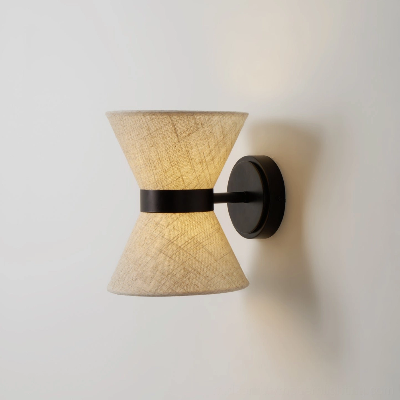 Renwick wall sconce showing symmetrical hourglass form and dual-shade light emission