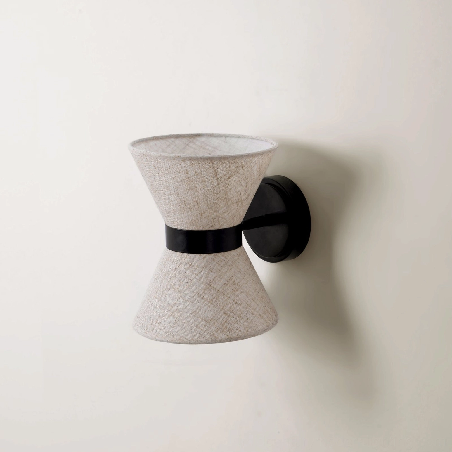 Renwick hourglass wall sconce installed in mid-century modern bedroom setting