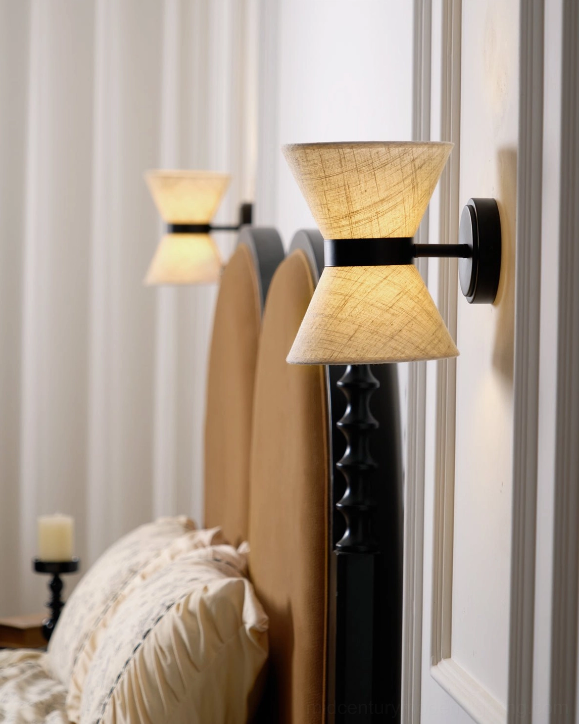 Renwick hourglass wall sconce demonstrating light distribution and warm glow effect