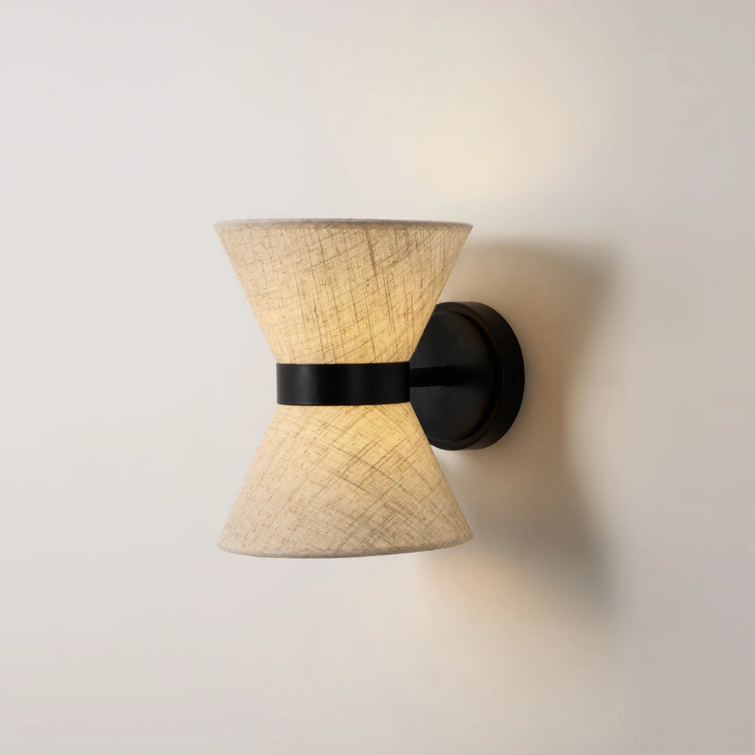 Renwick wall light creating layered ambient lighting in contemporary bedroom space