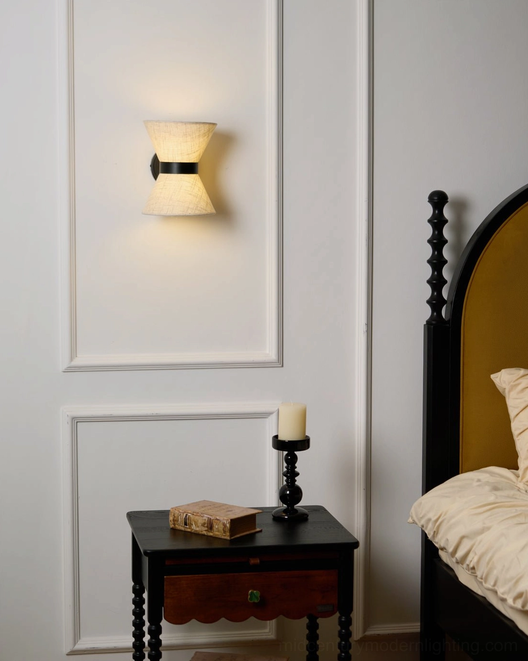 Ambient Renwick wall sconce in vintage paneled bedroom providing warm accent lighting