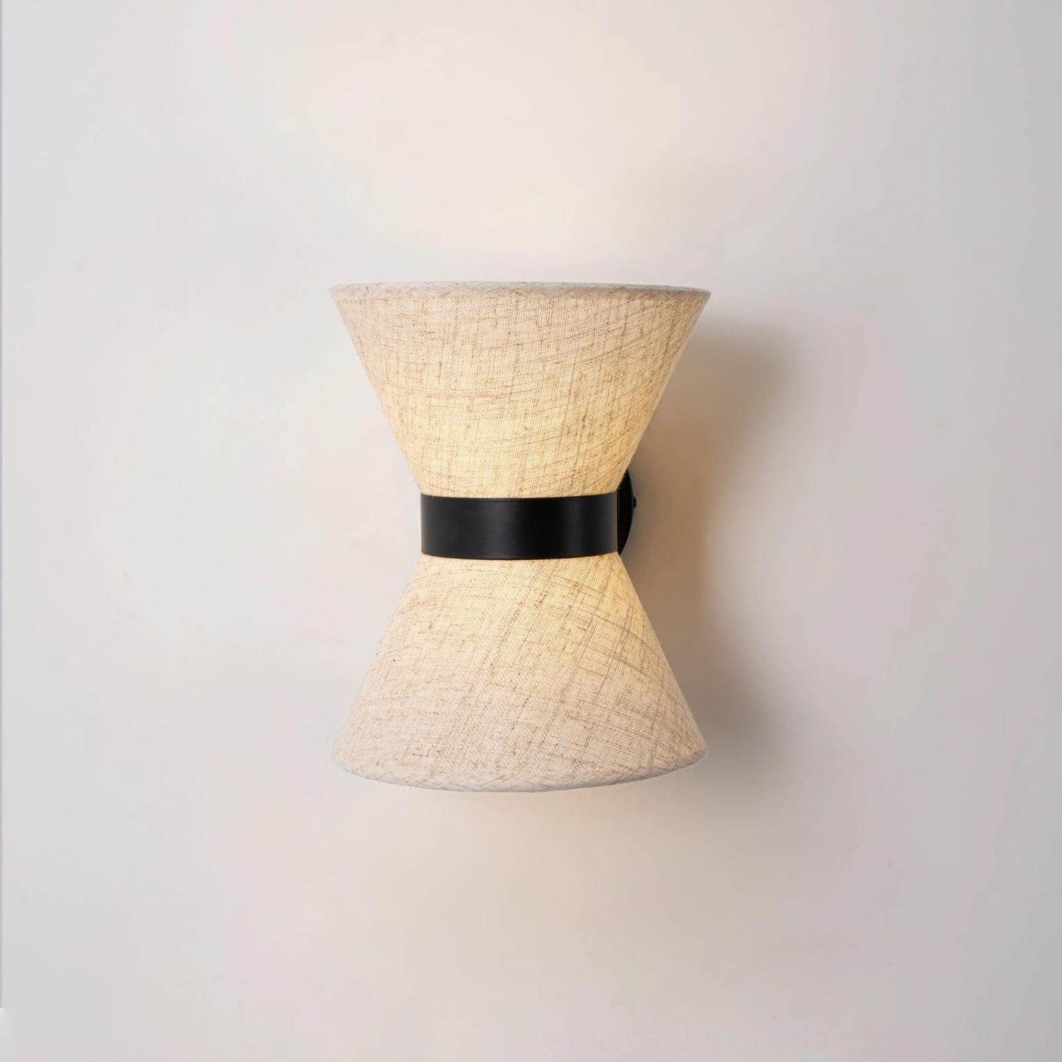 Detailed close-up of Renwick hourglass wall sconce showing linen weave texture and metal construction