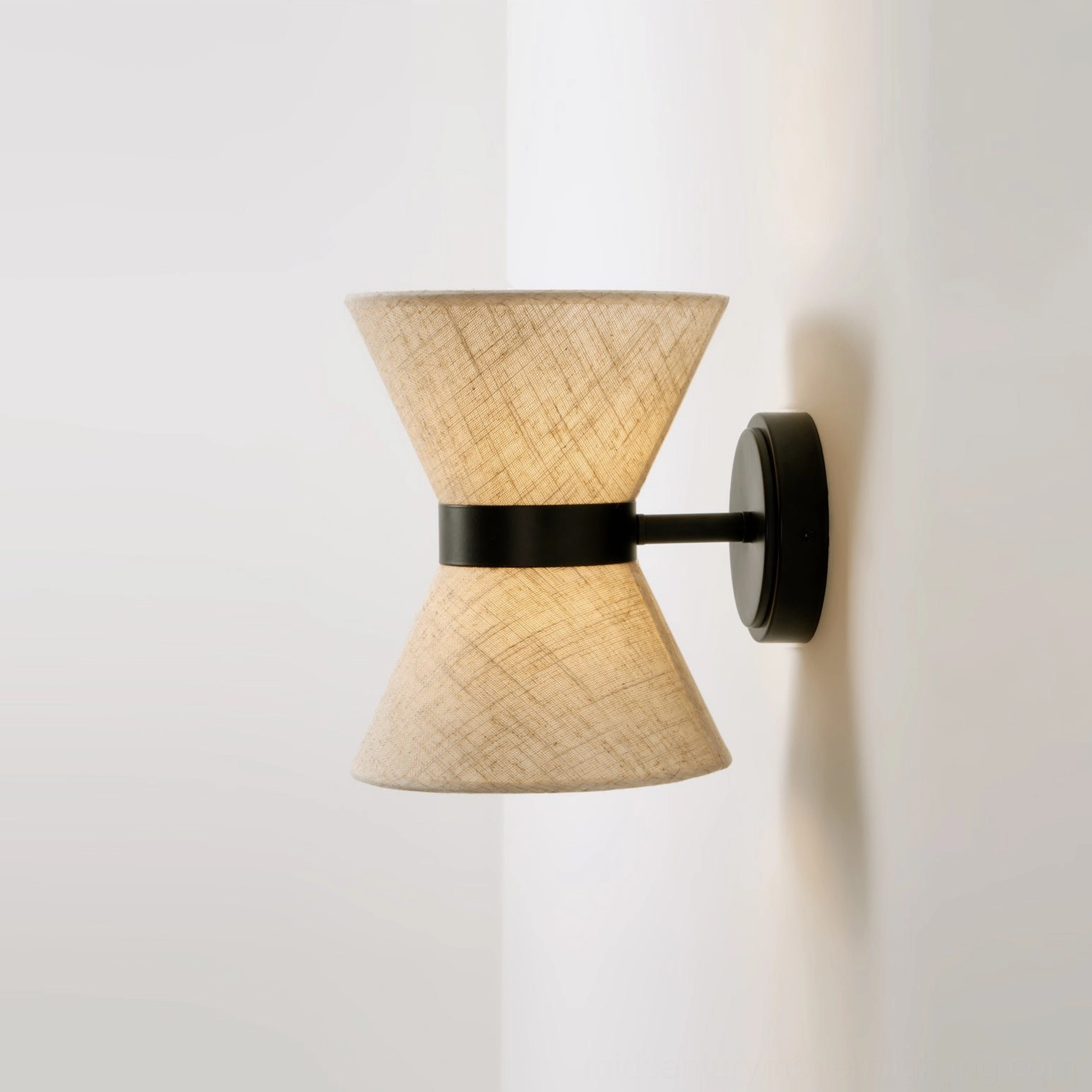 Renwick hourglass wall sconce showing matte black metal finish and linen diffuser design